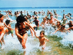 Beach-goers run from the water in a scene from the 1975 release of Jaws. SUPPLIED/FILE
