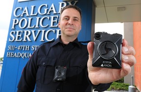 Calgary Police Service Staff Sgt. Travis Baker wears and holds the service’s new Axon body camera on July 3, 2018.