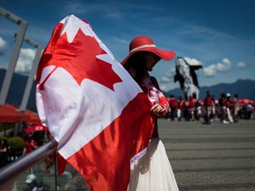 Summer Shen waves a Canadian flag while sporting a patriotic outfit during Canada Day celebrations in Vancouver, on July 1, 2019.