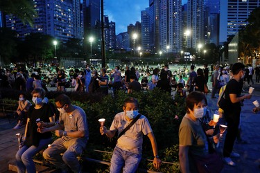 Protesters wearing protective face masks take part in a candlelight vigil to mark the 31st anniversary of the crackdown of pro-democracy protests at Beijing's Tiananmen Square in 1989, after police rejects a mass annual vigil on public health grounds, at Victoria Park, in Hong Kong, China June 4, 2020.