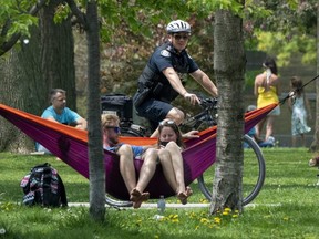 A bicycle police officer patrols Trinity Bellwoods Park in Toronto on Sunday, May 24, 2020.