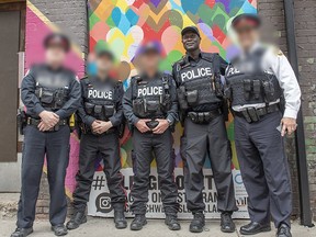 Toronto police constable Peter Roberts of 51 Division, second from the right, faces charges in a human trafficking investigation.
