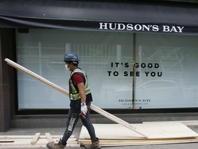 Workers board up Hudson's Bay Queen Street on Tuesday June 2, 2020.