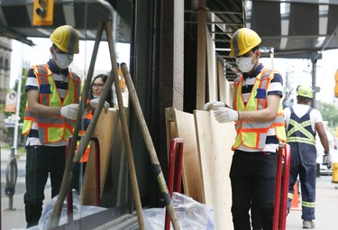 Workers board up Hudson's Bay Queen Street on Tuesday June 2, 2020. Veronica Henri/Toronto Sun/Postmedia Network