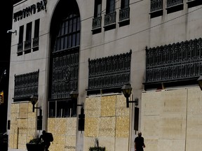 Workers board up Hudson's Bay Queen Street on Tuesday June 2, 2020.