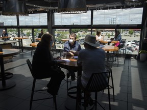 Patrons sit on the patio at Joey Sherway, part of the Joey Restaurant chain during the COVID-19 pandemic in Toronto on Wednesday, June 24, 2020. Toronto and the GTA entered stage two of opening.