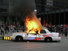 Toronto Police cruiser on fire in downtown Toronto during G20 Summit protest on June 26, 2010.