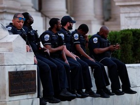 D.C. police officers rest during a protest against racial inequality in the aftermath of the death in Minneapolis police custody of George Floyd, in Washington, D.C., June 6, 2020.