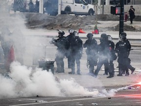 Police officers use tear gas next to the Colorado State Capitol as protests against the death of George Floyd continue on May 30, 2020 in Denver, Colorado.