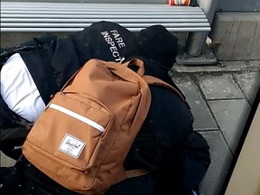 TTC fare inspectors on top of a male at a midtown streetcar platform in Feb. 2018.