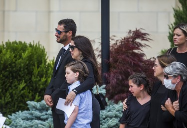 Michael Ciasullo, joined by his sister Connie Ciasullo, watches the caskets of his wife and children - Karolina, Klara, Lilianna and Mila Ciasullo  - as they are carried into St. Eugene de Mazenod Catholic Church during their funeral in Brampton, Ont. on Thursday June 25, 2020.  The family members were killed in a tragic collision in Brampton on June 18. Ernest Doroszuk/Toronto Sun/Postmedia