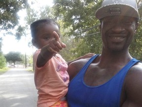 George Floyd, who died in Minneapolis police custody, is seen with his daughter Gianna in an undated family photo.