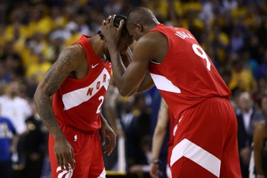OAKLAND, CALIFORNIA - JUNE 13:  Kawhi Leonard #2 and Serge Ibaka #9 of the Toronto Raptors celebrate late in the game against the Golden State Warriors during Game Six of the 2019 NBA Finals at ORACLE Arena on June 13, 2019 in Oakland, California.