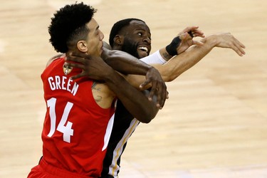 OAKLAND, CALIFORNIA - JUNE 13:  Danny Green #14 of the Toronto Raptors and Draymond Green #23 of the Golden State Warriors get tangled up in the second half during Game Six of the 2019 NBA Finals at ORACLE Arena on June 13, 2019 in Oakland, California.