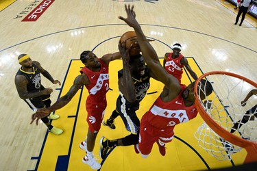 OAKLAND, CALIFORNIA - JUNE 13:  Draymond Green #23 of the Golden State Warriors attempts a shot against Kawhi Leonard #2 and Serge Ibaka #9 of the Toronto Raptors during Game Six of the 2019 NBA Finals at ORACLE Arena on June 13, 2019 in Oakland, California.