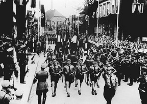 The Hitler Youth units parade in the streets of Soltau, in September 1937, in front of German nazi Führer and Chancellor Adolf Hitler (2nd L). The Hitler Youth was a paramilitary organization of the Nazi Party that existed from 1922 to 1945.