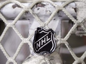 The NHL logo is seen on a goal at a Nashville Predators practice rink in Nashville, Tenn.