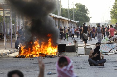 Iraqi demonstrators burn tires to block the road, amidst concerns about the spread of the coronavirus disease (COVID-19), as they demand the resignation of the governor of Najaf, Lauy al-Yassiri, during a protest in the holy city of Najaf, Iraq June 8, 2020.