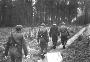 The peaceful Abbey of l’Abbaye d’Ardenne in France became headquarters for 33-year-old Standartenführer Kurt Meyer and his 20,000-member, 12th SS Panzer Division Hitlerjugend. Charged with war crimes after the war, Meyer is seen here handcuffed to Maj. Arthur Russell and escorted by two Royal Winnipeg Rifles in Aurich, Germany, on Nov. 12, 1945. NATIONAL DEFENCE COLLECTION
