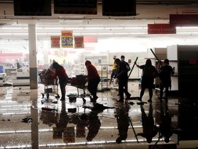 Looters walk through a destroyed K Mart during demonstrations in reaction to the death in Minneapolis police custody of George Floyd in Minneapolis May 30, 2020.