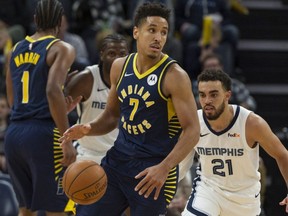 Pacers guard Malcolm Brogdon (7) handles the ball against Grizzlies guard Tyus Jones (21) during NBA action in Memphis, Dec. 2, 2019.