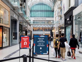 People walk in the Eaton Centre shopping mall, as the province's phase two of reopening from COVID-19 restrictions begins in Ontario on June 24, 2020.