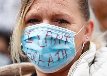 A woman wearing a painted protective face mask during a Black Lives Matter protest in Centenary Square in Birmingham, following the death of George Floyd who died in police custody in Minneapolis, Birmingham, Britain, June 4, 2020.