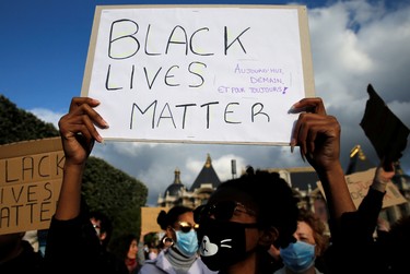 A protester holds a sign during a banned demonstration in memory of Adama Traore, a 24-year-old black Frenchman who died in a 2016 police operation which some have likened to the death of George Floyd in the United States, on the Place de la Republique in Lille, France June 4, 2020. The sign reads "Black Lives Matter. Today, Tomorrow and for Always".