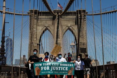 Current and former New York City Mayor's staff march across the Brooklyn Bridge to call for reforms during a protest against racial inequality in the aftermath of the death in Minneapolis police custody of George Floyd, in New York City, New York, U.S. June 8, 2020. REUTERS/Brendan McDermid ORG XMIT: PPPNYK510