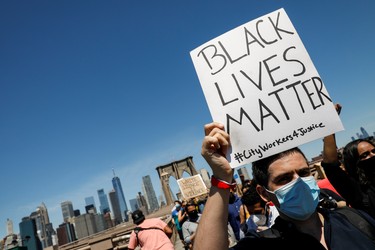 Current and former New York City Mayor's staff march across the Brooklyn Bridge to call for reforms during a protest against racial inequality in the aftermath of the death in Minneapolis police custody of George Floyd, in New York City, New York, U.S. June 8, 2020.