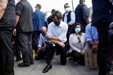 Canada's Prime Minister Justin Trudeau wears a mask as he takes a knee during a rally against the death in Minneapolis police custody of George Floyd, on Parliament Hill, in Ottawa, Ontario, Canada June 5, 2020.