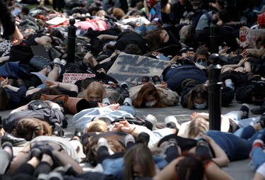 Demonstrators lie on the ground during a protest over police brutality towards African-Americans in the United States, after the death of George Floyd in Minneapolis police custody, in front of the U.S. embassy in Warsaw, Poland, June 4, 2020.