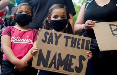 Children stand with their family as they attend a rally and march calling for a defunding of Seattle police, in Seattle, Washington, U.S. June 3, 2020.