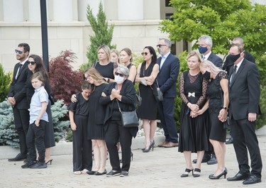 Immediate family members react as they watch the arrival of the caskets of Karolina Ciasullo and her three young daughters, six-year-old Klara Ciasullo, four-year-old Lilianna Ciasullo and one-year-old Mila Ciasullo who were killed in a fatal vehicle crash last week during their funeral service in Brampton, Ont., on Thursday, June 25, 2020. The funeral is limited for people attending due to the COVID-19 pandemic.