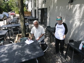 Stratengers Restaurant and Bar owners Dharam Vijh, left, and his brother, Anil, prepare their patio for eventual reopening on Thursday, June 4, 2020 in Leslieville.