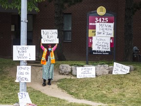 A protestor holds a sign near the scene of the death the death of 62-year-old Ejaz Choudry during a police involved shooting on Saturday, the intersection of Morning Star Dr. and Goreway Dr. is blocked in Mississauga, Ont. on Monday June 22, 2020.