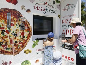 An automated pizza machine delivers hot pizza in three minutes in Port Carling on Thursday, June 18, 2020.