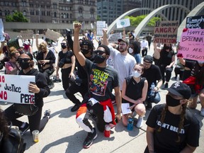 Protesters gather at city hall in Toronto to honour black lives lost at the hands of police, on Friday, June 5, 2020.