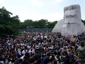 People gather at the Martin Luther King Jr. Memorial during a peaceful protest against police brutality and the death of George Floyd, on June 4, 2020, in Washington, D.C.