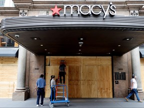 Workers board up the Macy’s store in Herald Square after it was damaged and looted by protesters who participated in demonstrations against the death in Minneapolis police custody of George Floyd, in the Manhattan borough of New York City, U.S., June 2, 2020. (MIKE SEGAR/REUTERS)