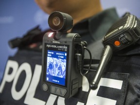 A Toronto police officer models a body-worn camera sample in May, 2015.