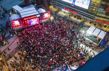 Fans get ready to watch the Toronto Raptors take on the Golden State Warriors during Game 6 NBA Finals action screened at Jurassic Park outside of the Scotiabank Arena in Toronto, Ont. on Thursday June 13, 2019.Sun/Postmedia