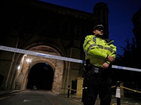 Police officers secure a police cordon near Forbury Gardens park in Reading, west of London, on Saturday, June 20, 2020 following a stabbing incident.