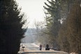 A family of four from Pakistan walk down Roxham Road in Champlain, N.Y. towards the U.S.-Canada border on Feb. 28, 2017.