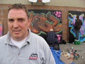 Const. Scott Mills, Toronto Police Service Legal Graffiti Art Coordinator and Toronto Crime Stoppers Community Youth Officer, poses in front of some Legal Graffiti in Toronto on June 1, 2009.