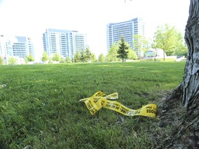 Yellow police tape and shattered window glass from a minivan remain at the crime scene on Wednesday, June 10, 2020, at Research Rd. in the upper Thorncliffe Park area, where a man in his 20s was shot dead during a drive-by shooting Tuesday night.