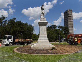 A construction team prepares to remove a statue of Confederate commander Richard W. Dowling ahead of Juneteenth in Houston, Texas, June 17, 2020.