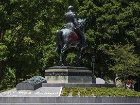 Graffiti is visible on the King Edward VII Equestrian statue north of the provincial legislature Tuesday.