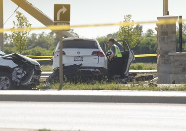 Special Investigations Unit officers investigate multiple car collision at the intersection at Torbram Rd. and Countryside Dr. In Brampton. A blue G35 Infiniti may have set off the crash that has killed a woman and three children around noon. A white VW Touareg smashed into a utility pole and had the driver's side crushed in on Thursday on Thursday June 18, 2020. Jack Boland/Toronto Sun/Postmedia Network