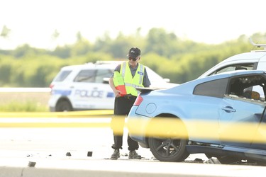 Special Investigations Unit officers investigate multiple car collision at the intersection at Torbram Rd. and Countryside Dr. In Brampton. A blue G35 Infiniti may have set off the crash that has killed a woman and three children around noon. A white VW Touareg smashed into a utility pole and had the driver's side crushed in on Thursday on Thursday June 18, 2020. Jack Boland/Toronto Sun/Postmedia Network